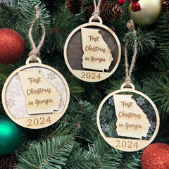 Georgia-shaped First Christmas in Georgia ornament hanging on a festive holiday tree with twinkling lights and lush branches. A delightful keepsake to celebrate a memorable first Christmas in the Peach State, full of warmth and southern charm.