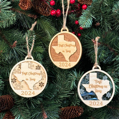 Texas-shaped First Christmas in Texas ornament hanging on a glowing holiday tree with twinkling lights and festive greenery. A perfect keepsake to celebrate a memorable first Christmas in the Lone Star State, reflecting its bold spirit and warm holiday cheer.