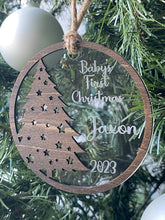 Baby's First Christmas Ornament featuring a festive Christmas tree design, personalized with baby’s name, year, and 'Baby’s First Christmas' text. A beautiful keepsake to celebrate a newborn’s first holiday season, perfect for adding a personal touch to Christmas trees and holiday decor.