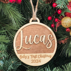 Baby's First Christmas Ornament with multiple design options, personalized with baby’s name, year, and 'Baby’s First Christmas' text. A charming keepsake to celebrate a newborn’s first holiday season, offering a variety of designs to suit every style. Perfect for adding a special touch to Christmas trees and holiday decor.