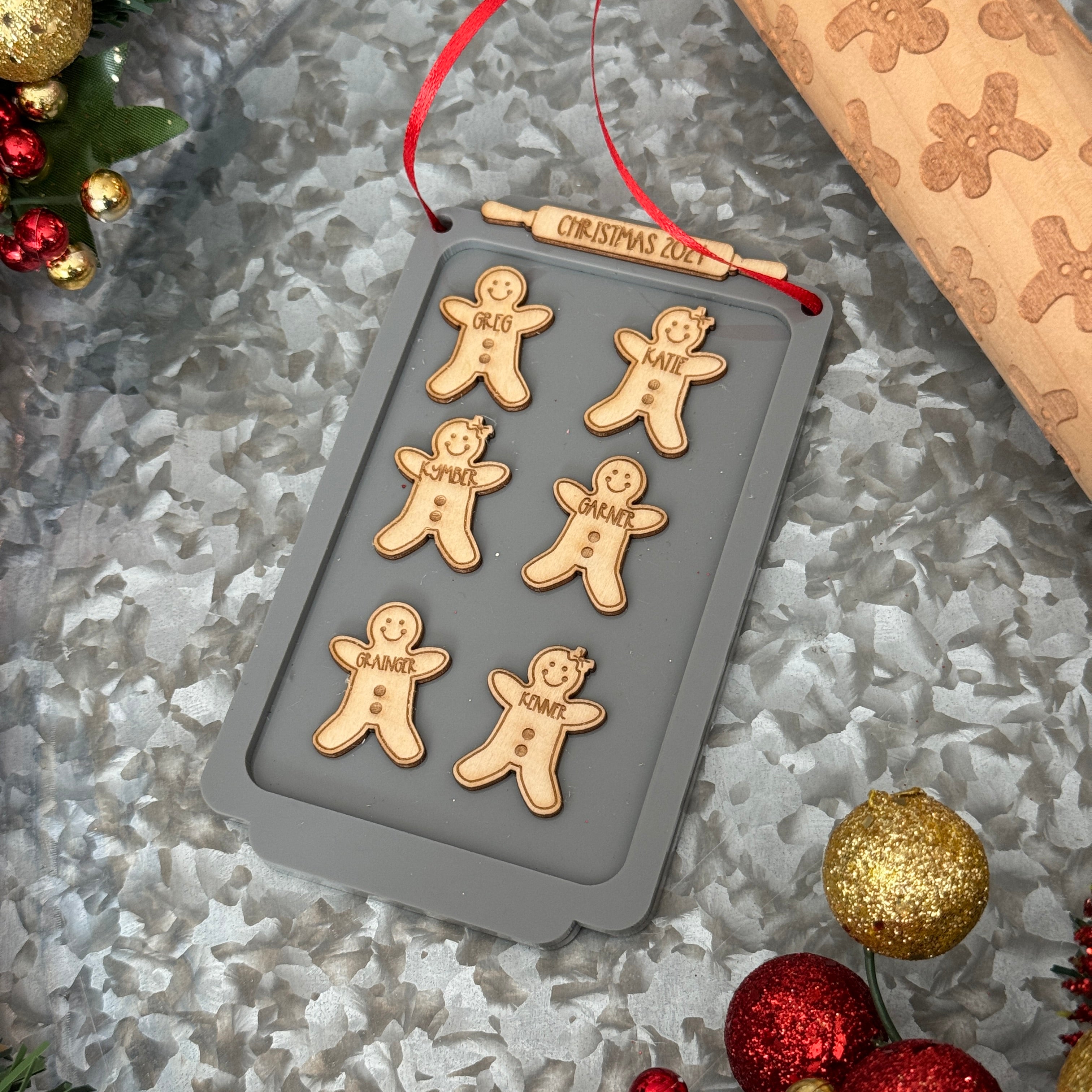 Gingerbread Family Ornament, featuring a charming design of gingerbread figures personalized with family members' names. A festive and sweet keepsake to celebrate family traditions and add a personal touch to your Christmas tree.