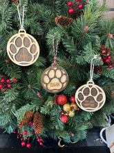 Ornament for Dog Lovers, featuring "Puppy's First Christmas" or a Pet Memorial design, shaped like a paw and personalized with your pet's name. A heartfelt keepsake to celebrate a new puppy’s first holiday or honor a cherished pet, adding a special and personalized touch to your Christmas tree.