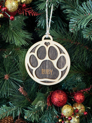 Ornament for Dog Lovers, featuring "Puppy's First Christmas" or a Pet Memorial design, shaped like a paw and personalized with your pet's name. A heartfelt keepsake to celebrate a new puppy’s first holiday or honor a cherished pet, adding a special and personalized touch to your Christmas tree.