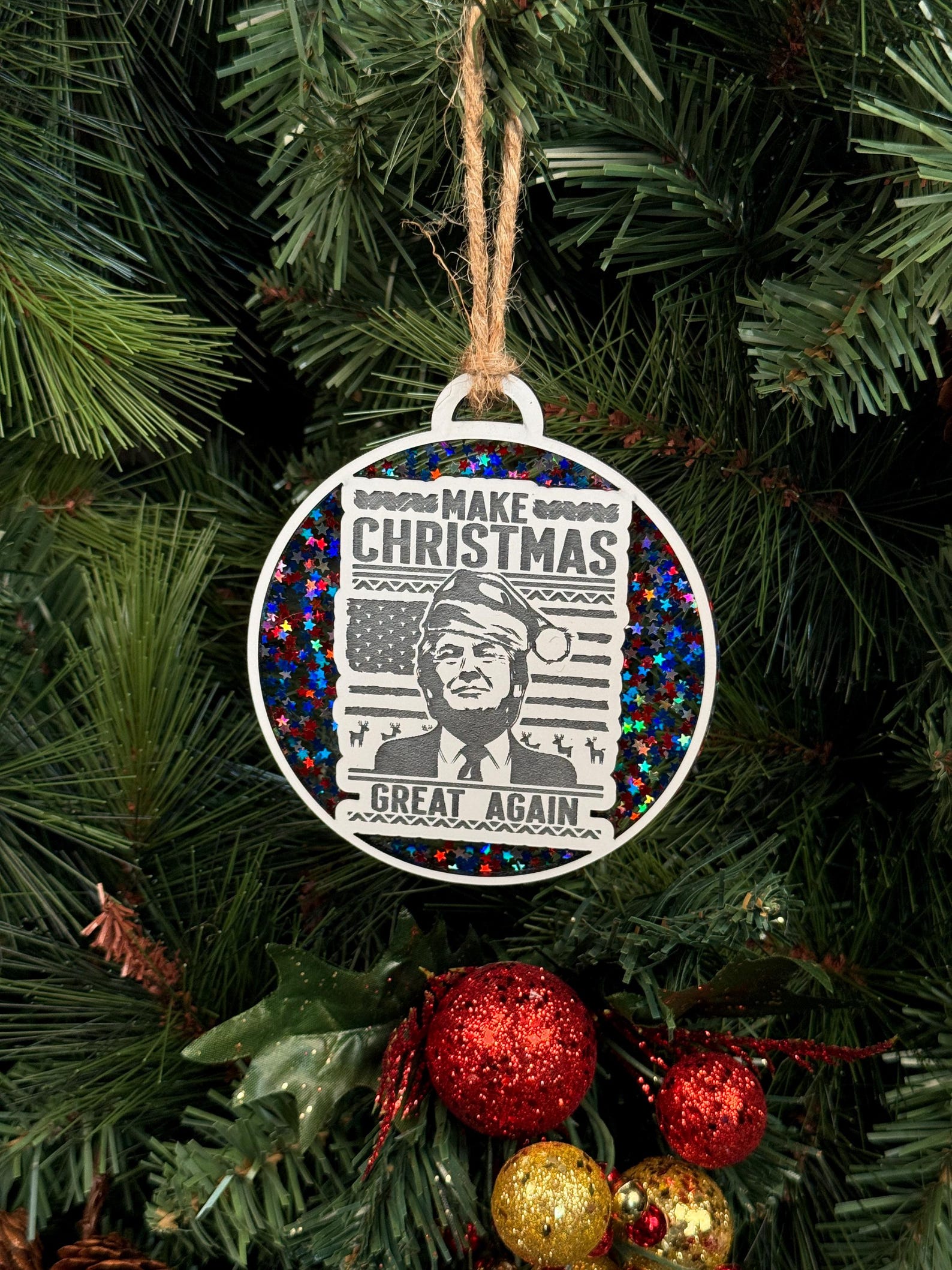 Donald Trump Christmas Ornament featuring the "Make Christmas Great Again" slogan. A fun and unique keepsake for political supporters, perfect for adding a personal touch to your holiday decor or giving as a gift to fans of Donald Trump.