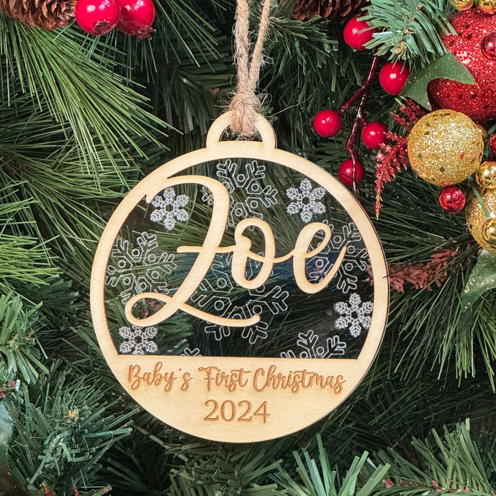 Baby's First Christmas Ornament with multiple design options, personalized with baby’s name, year, and 'Baby’s First Christmas' text. A charming keepsake to celebrate a newborn’s first holiday season, offering a variety of designs to suit every style. Perfect for adding a special touch to Christmas trees and holiday decor.
