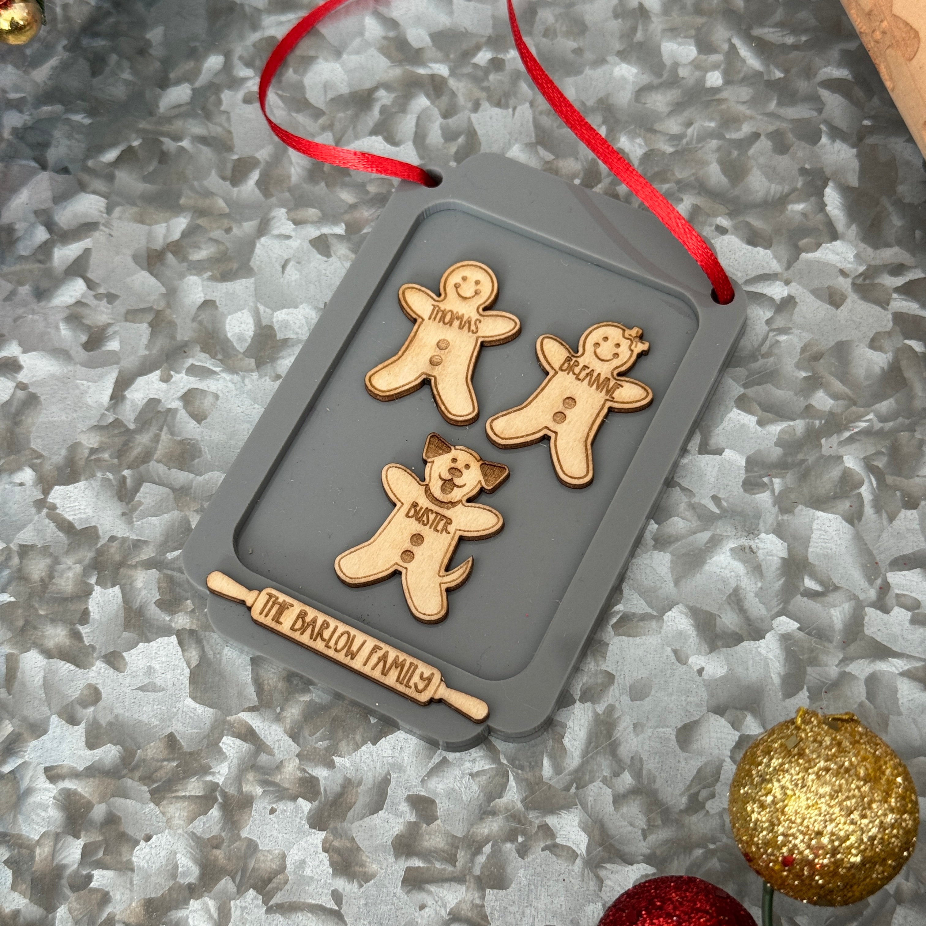 Gingerbread Family Ornament, featuring a charming design of gingerbread figures personalized with family members' names. A festive and sweet keepsake to celebrate family traditions and add a personal touch to your Christmas tree.