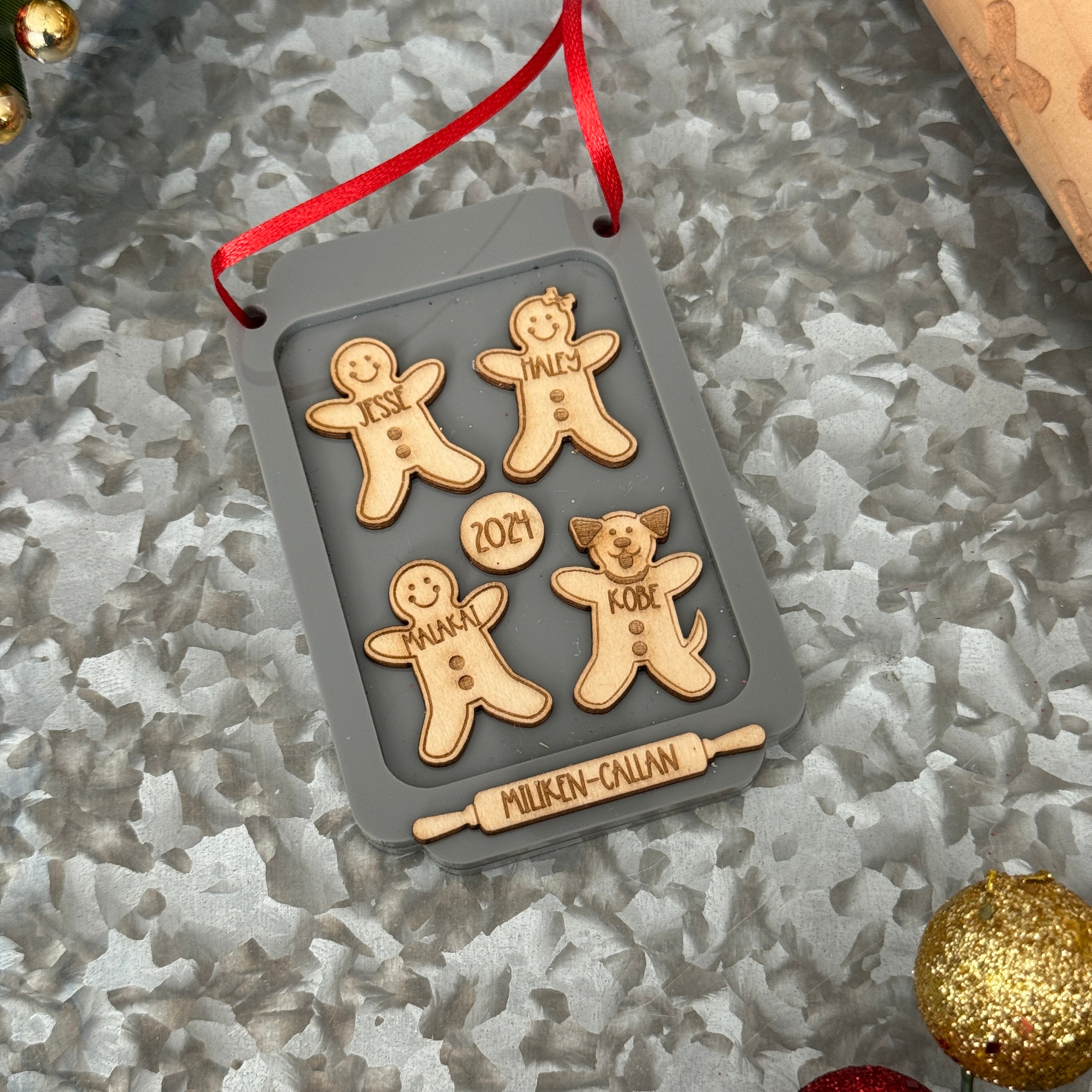 Gingerbread Family Ornament, featuring a charming design of gingerbread figures personalized with family members' names. A festive and sweet keepsake to celebrate family traditions and add a personal touch to your Christmas tree.