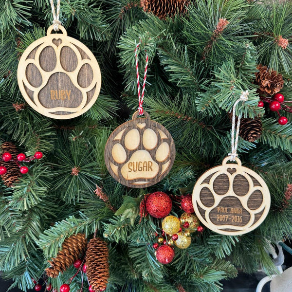 Ornament for Dog Lovers, featuring "Puppy's First Christmas" or a Pet Memorial design, shaped like a paw and personalized with your pet's name. A heartfelt keepsake to celebrate a new puppy’s first holiday or honor a cherished pet, adding a special and personalized touch to your Christmas tree.