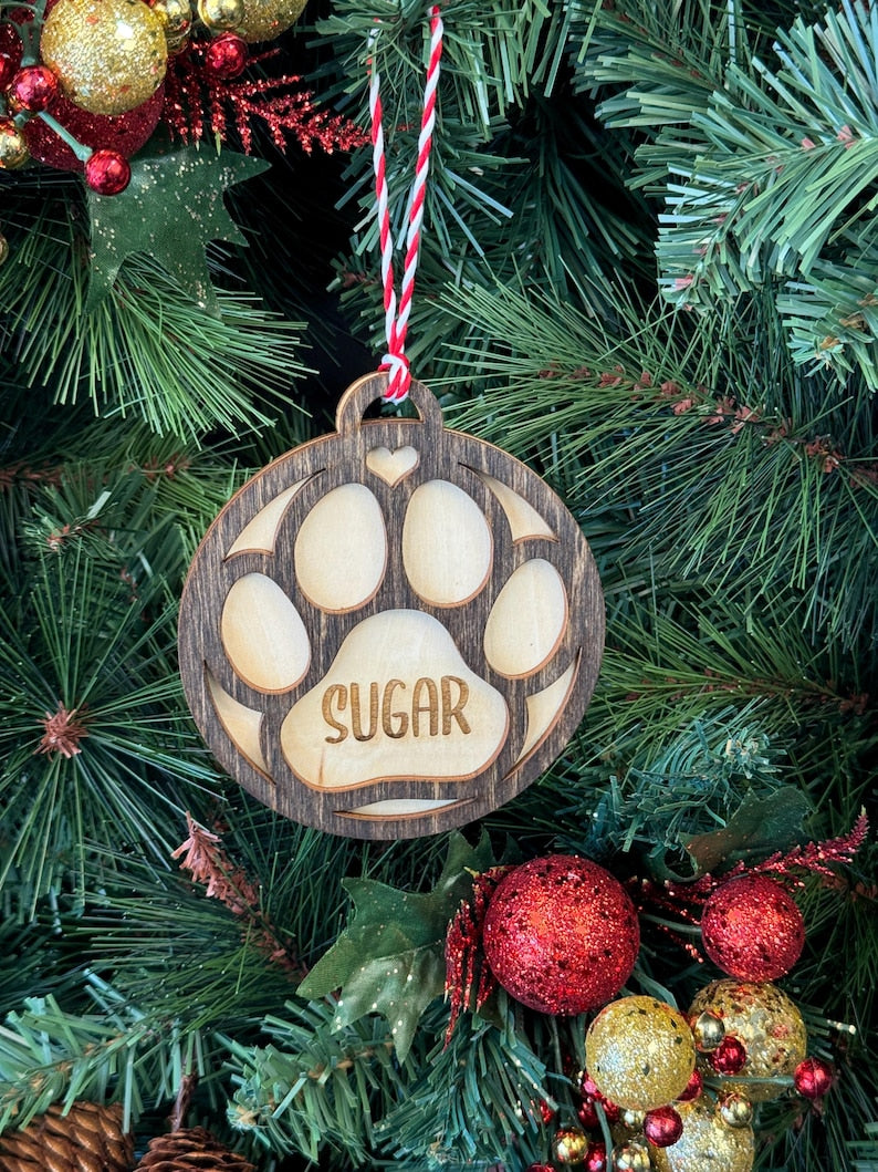 Ornament for Dog Lovers, featuring "Puppy's First Christmas" or a Pet Memorial design, shaped like a paw and personalized with your pet's name. A heartfelt keepsake to celebrate a new puppy’s first holiday or honor a cherished pet, adding a special and personalized touch to your Christmas tree.
